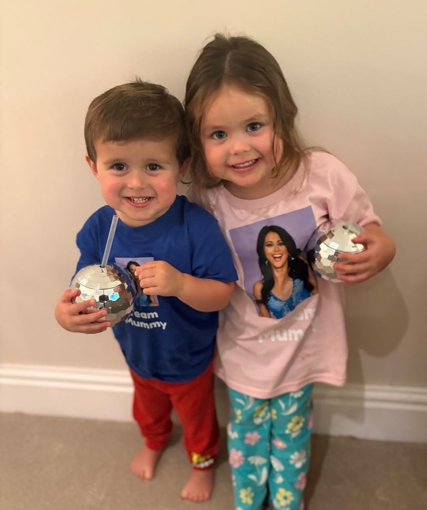 brother and sister smiling with sparkly cups 