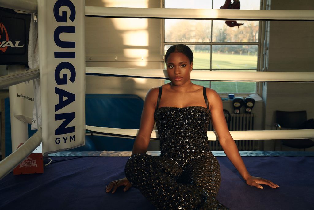 A woman dressed elegantly inside a boxing ring