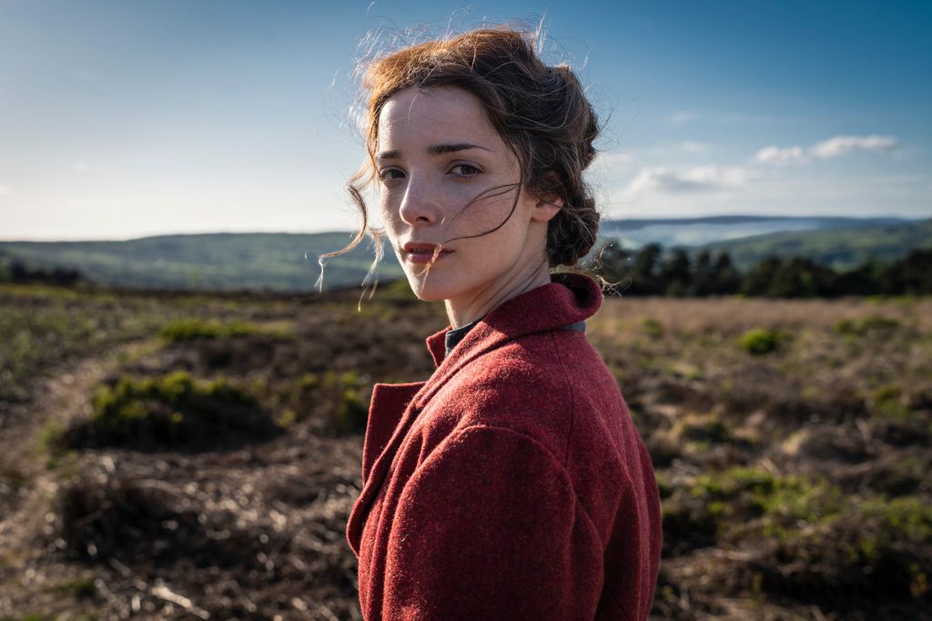 close up of young woman standing in field