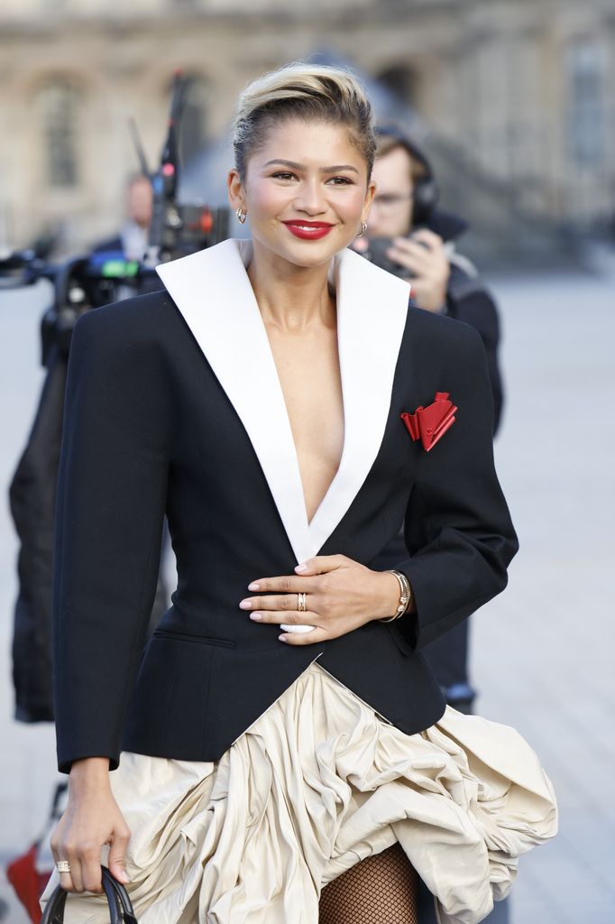 Zendaya spotted with a red geometric brooch outside the Louis Vuitton SS25 show in Paris 