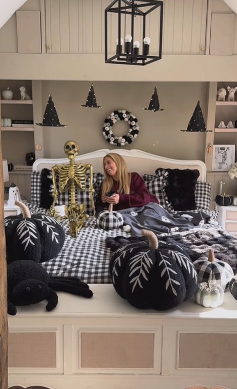 Stacey Solomon on bed surrounded by Halloween decorations