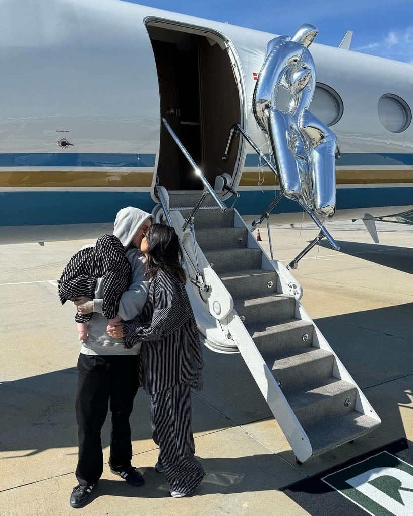 Travis Barker and Kourtney Kardashian outside their private plane