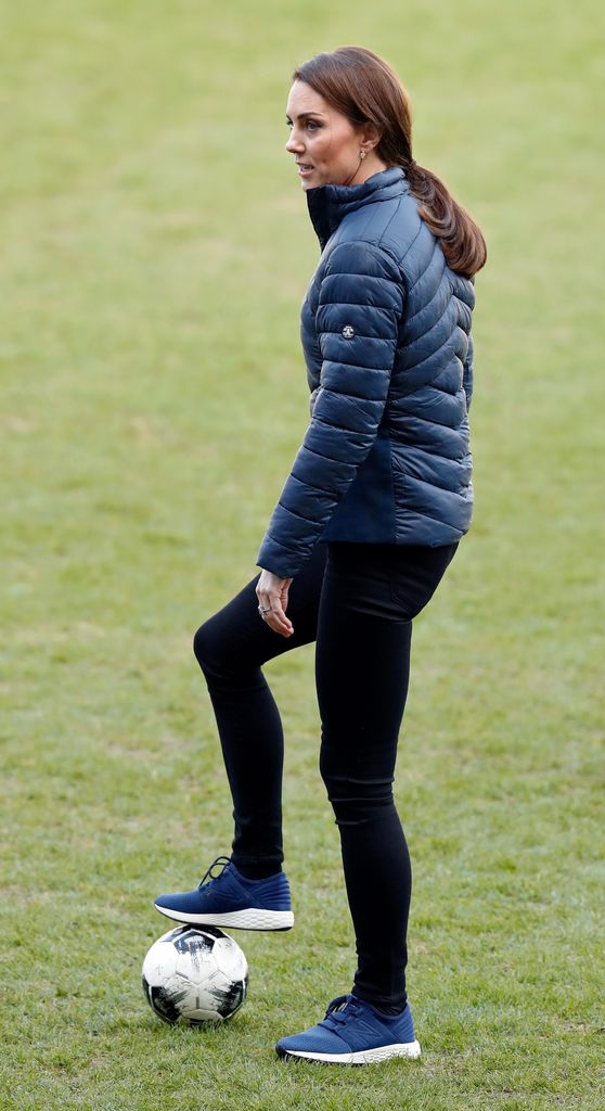 Princess Kate with her foot on a football