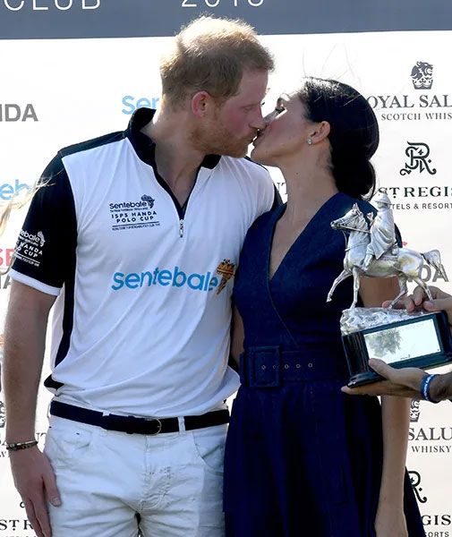 The Duke and Duchess of Sussex kiss at the polo