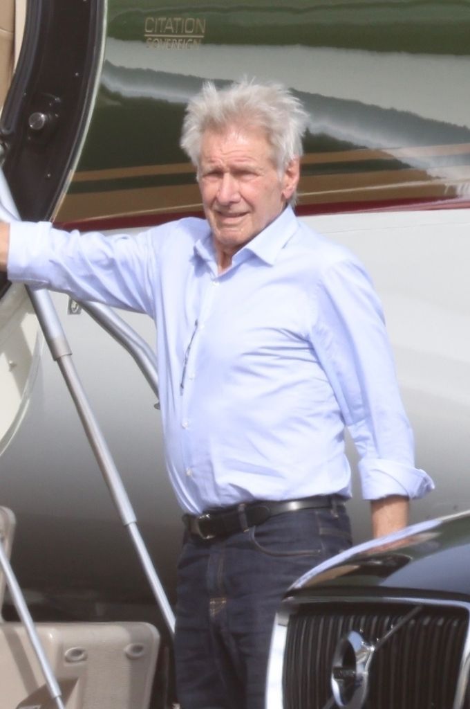 Harrison Ford looks happy and healthy at LAX Airport in a blue Oxford shirt 