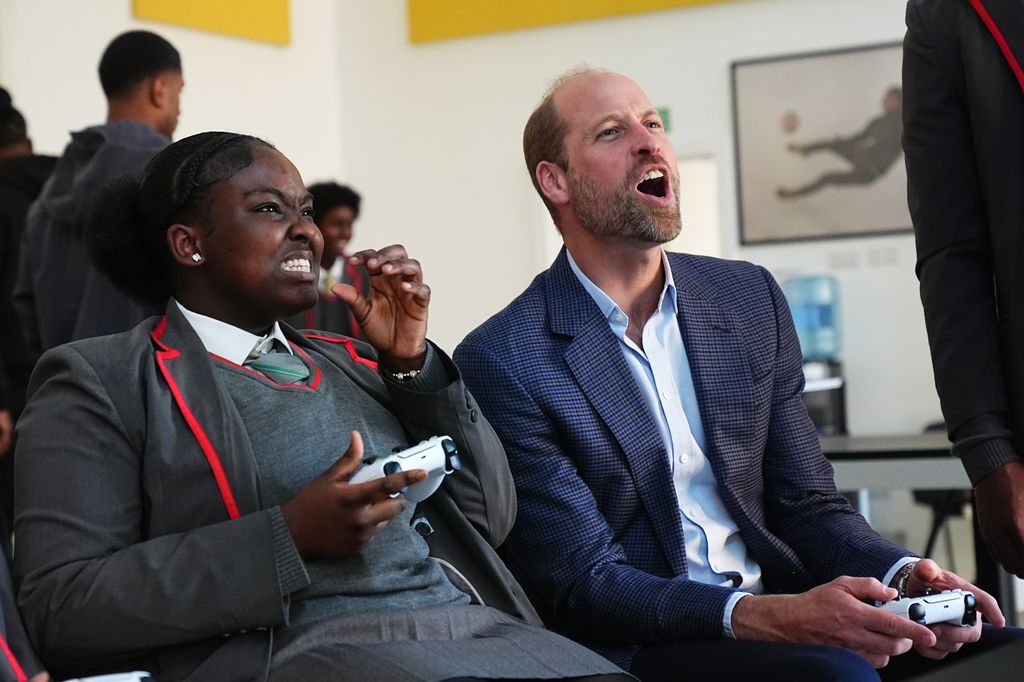 Prince William reacts as he plays computer game
