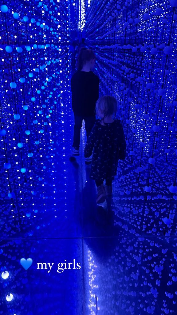 two sisters walking through art exhibition