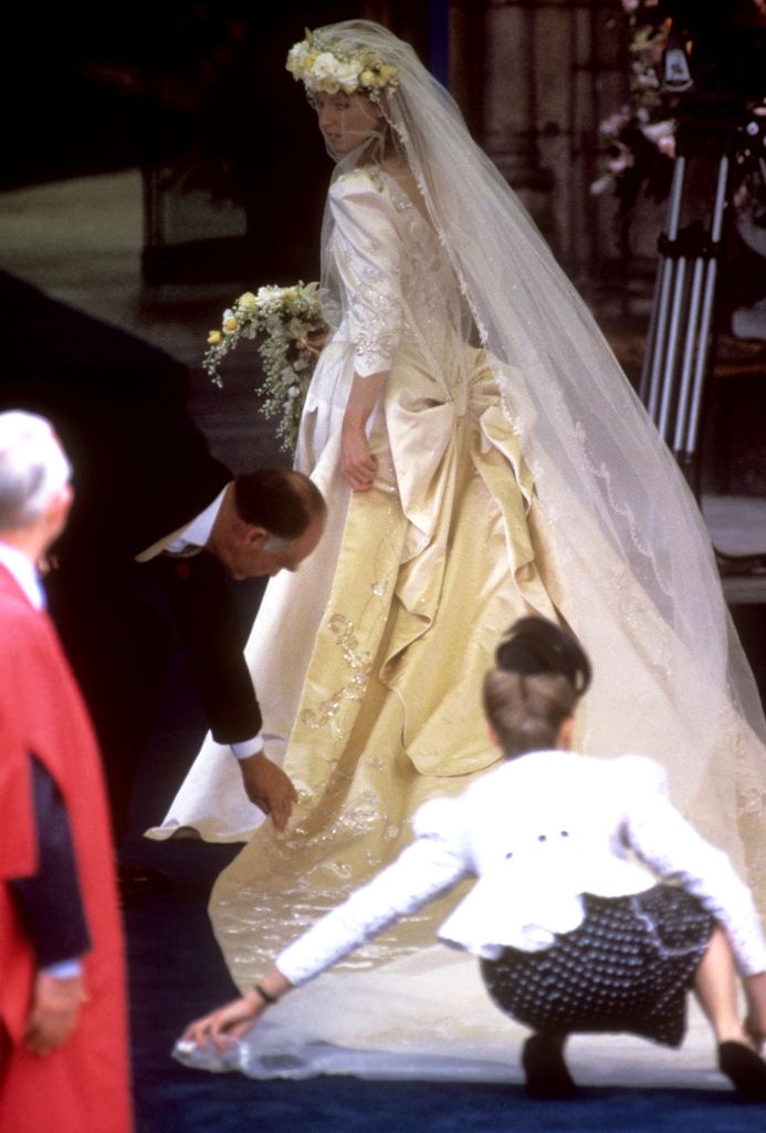 Sarah Ferguson getting help with her bridal train at Westminster Abbey