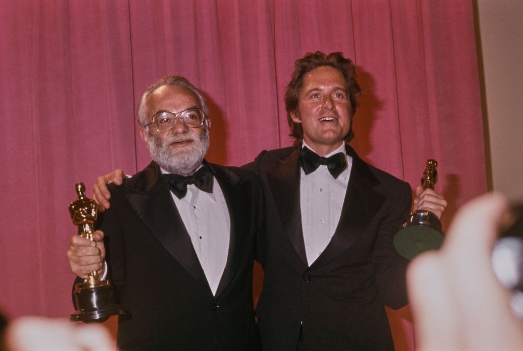 American film producer Saul Zaentz (left) and American actor and film producer Michael Douglas backstage after winning the 'Best Picture' award for 'One Flew Over the Cuckoo's Nest' 