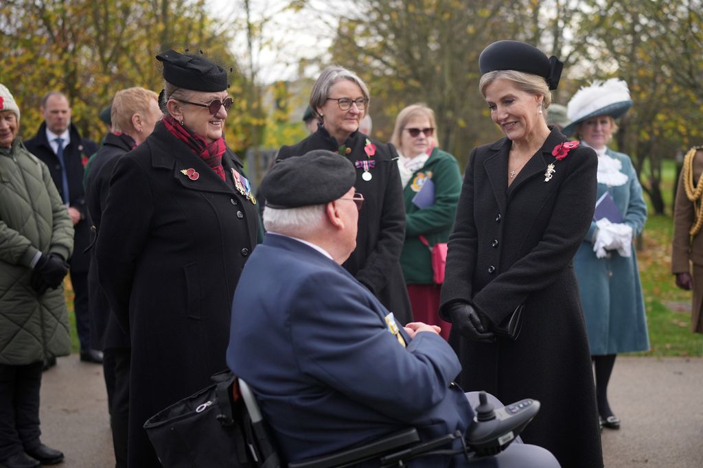 Sophie talks to veterans after the Armistice Day commemoration at the National Memorial Arboretum