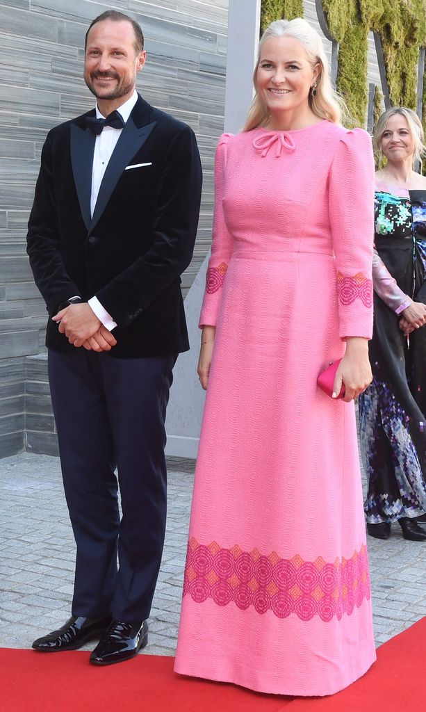 Crown Princess Mette-Marit  in pink dress with Haakon in black tie