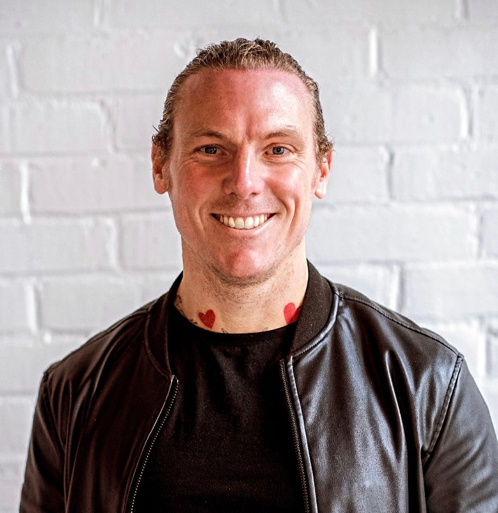 Man smiling in black leather jacket