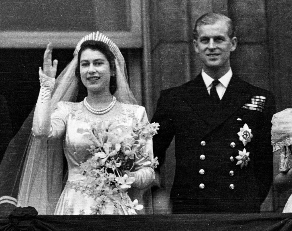 Princess Elizabeth and the Duke of Edinburgh waving to crowds on the balcony of Buckingham Palace after their wedding
