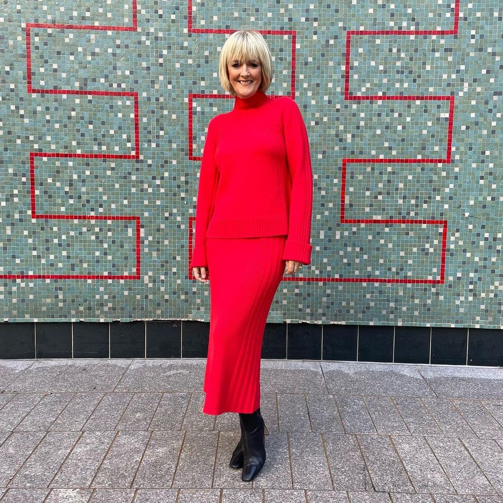 Jane Moore at ITV Loose Women studios in red jumper and pleated skirt 