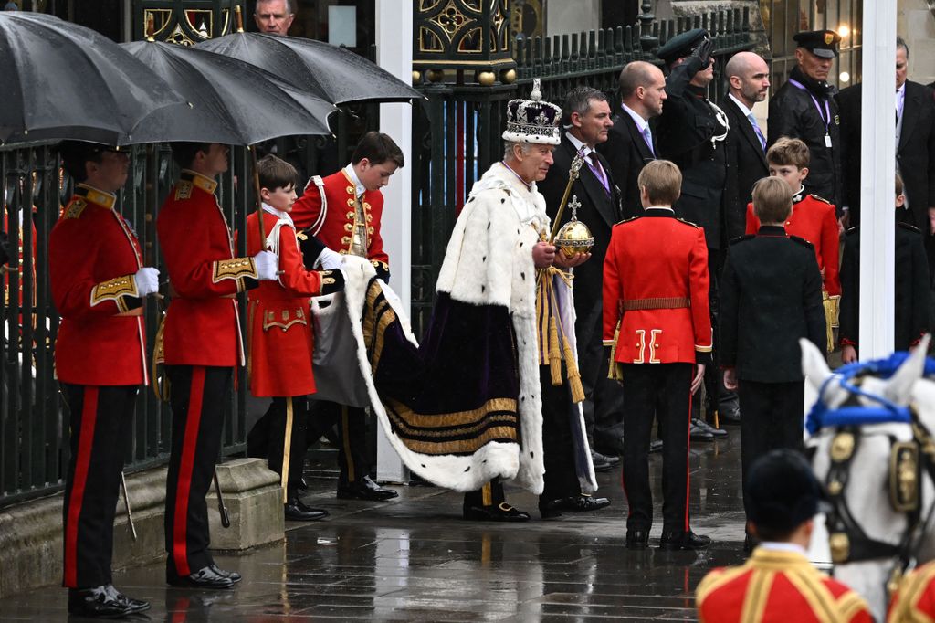 King Charles III wearing the Imperial state Crown leaves Westminster Abbey