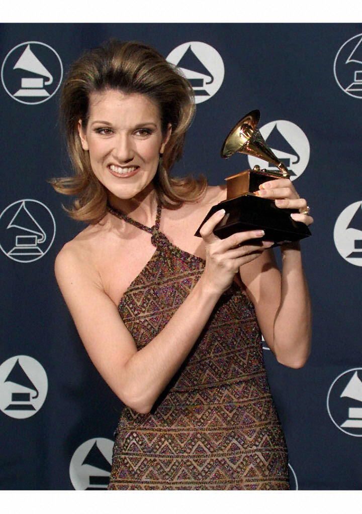 Celine Dion holds up her Grammy Award 26 February at Madison Square Garden in New York. Dion won Best Pop Album for "Falling Into You."