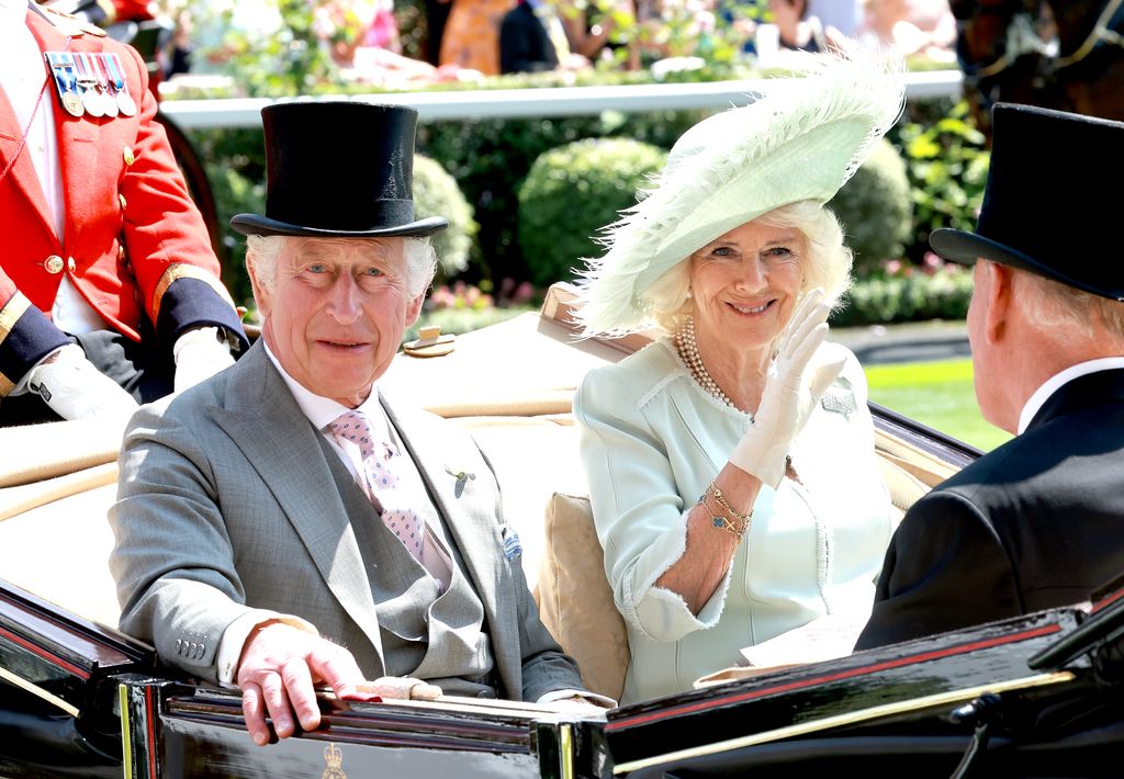 : King Charles II and Queen Camilla arrive into the parade ring in the royal carriage procession as they attend day three of Royal Ascot 2023