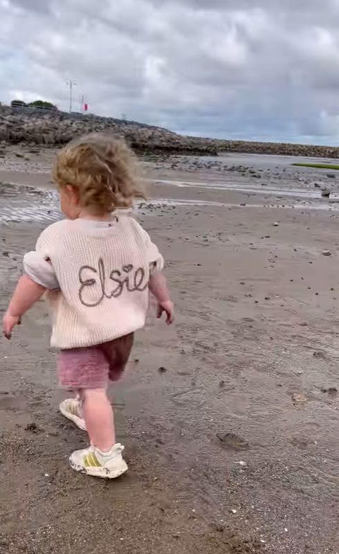 A young girl running on the beach