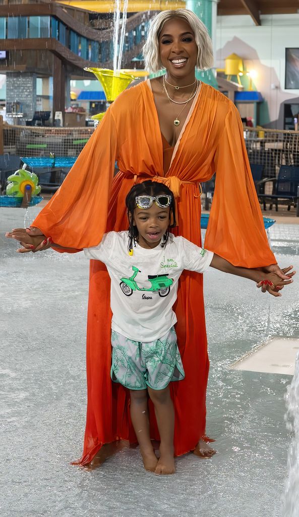 Kelly Rowland in orange gown with son at waterpark