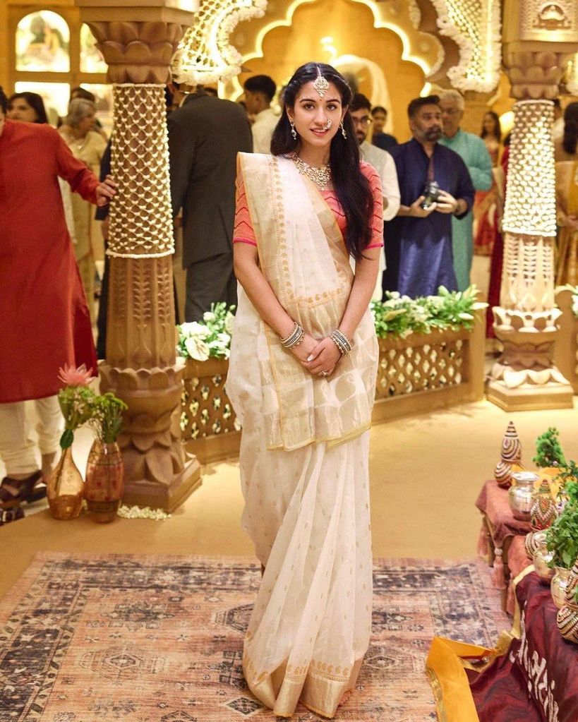 Radhika merchant in gold and cream sari