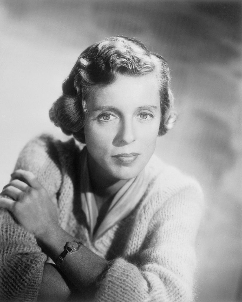 Nancy posing in a cardigan in black and white