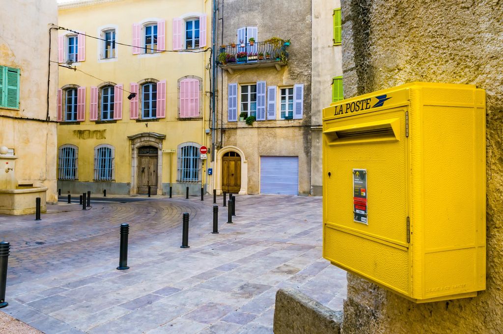 A yellow classical postbox in the little town of Brignoles, in Provence a region of the south of France