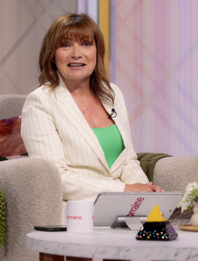 Lorraine Kelly in a striped suit and blue shirt