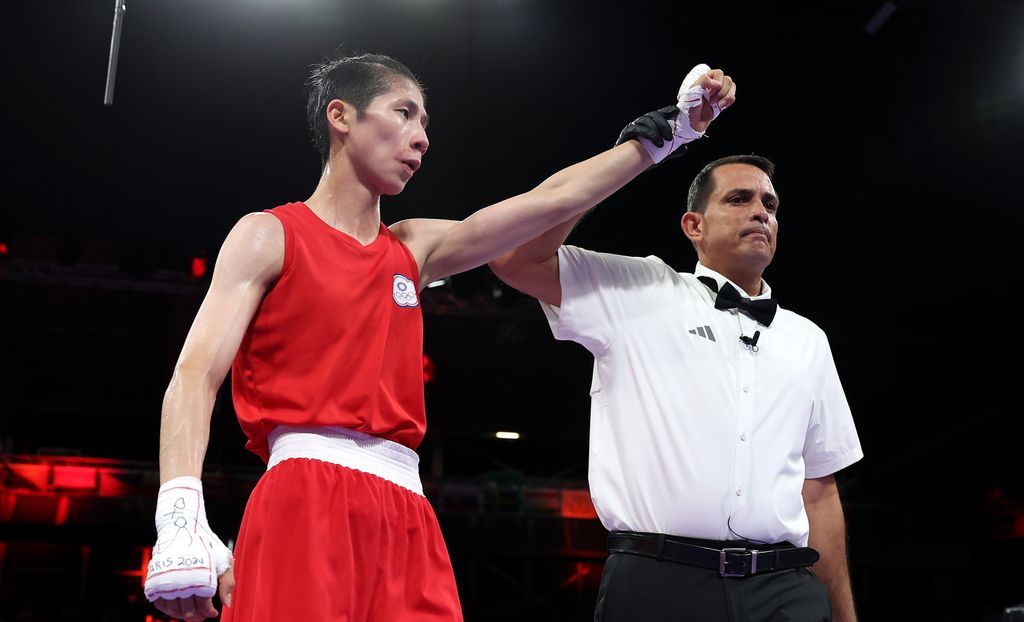 A referee holding Lin Yu-Ting's arm aloft