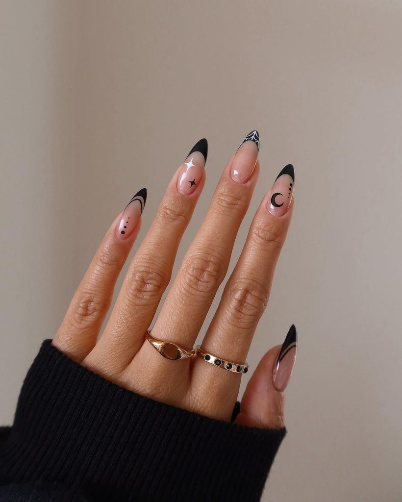 Nails with black tips and moon and stars art