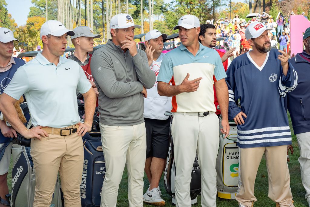 a group of golfers watching tournament