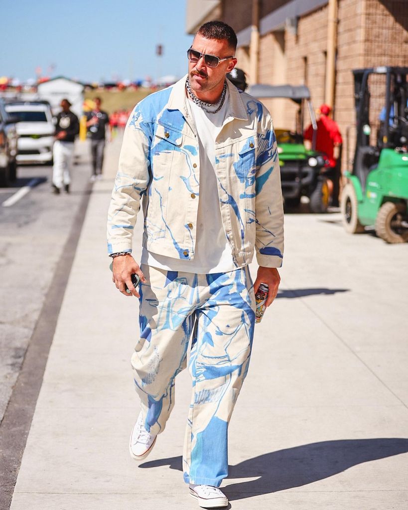 travis kelce white denim jeans and jacket with blue paint splashes