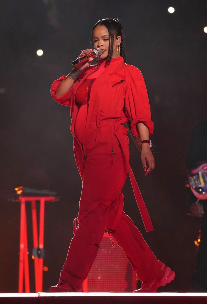 Rihanna performing in red with baby bump