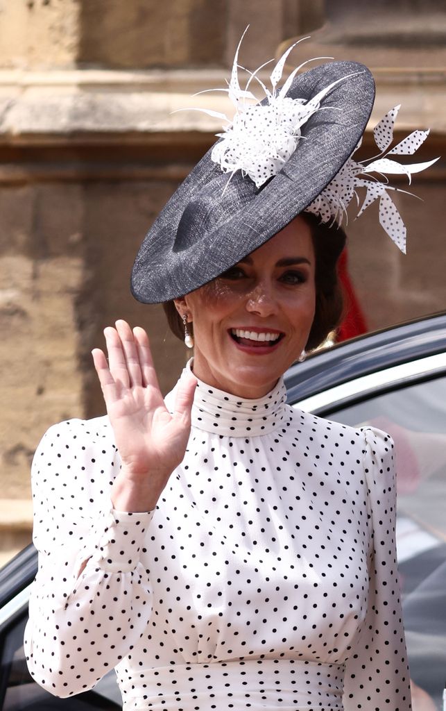 The Princess of Wales wearing a black and white polka dot dress and hat waving as she arrived at St George's Chapel to attend the Order Of The Garter Service 