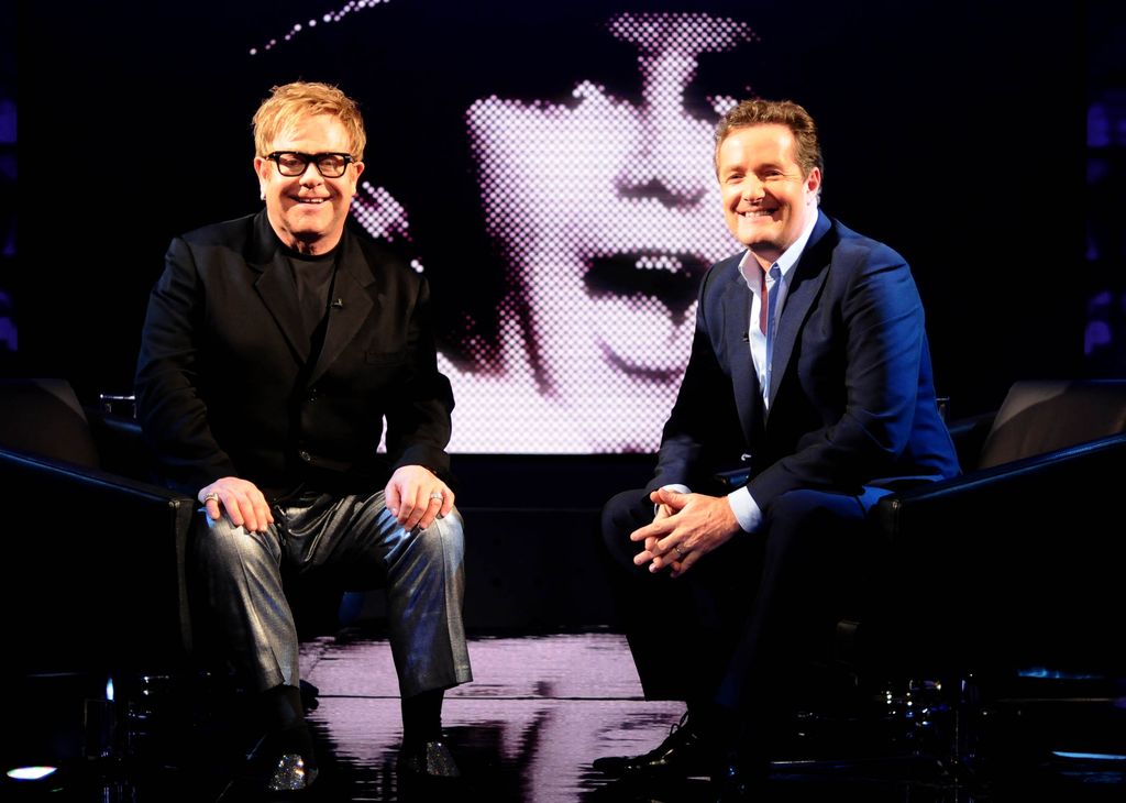 Elton John sitting with Piers Morgan