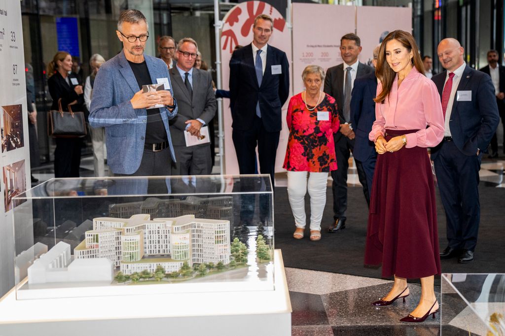 Queen Mary looking at a model of the future Mary Elizabeth's Hospital