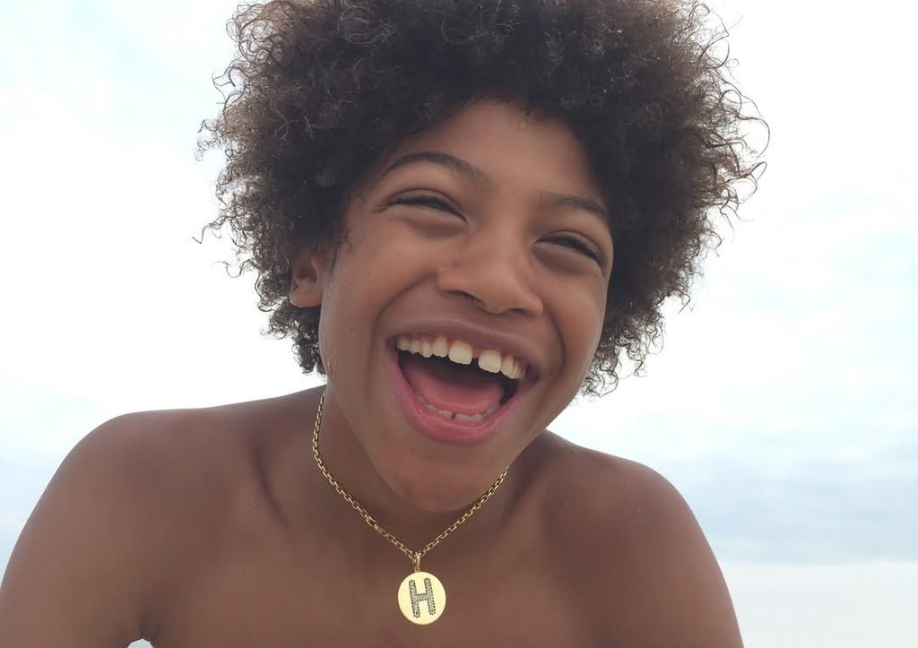 Henry Samuel smiling for the camera with gold chain