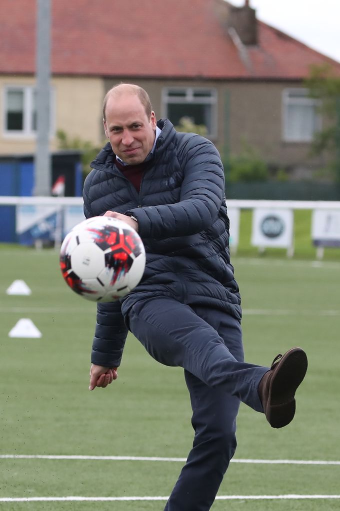 Prince William kicks football