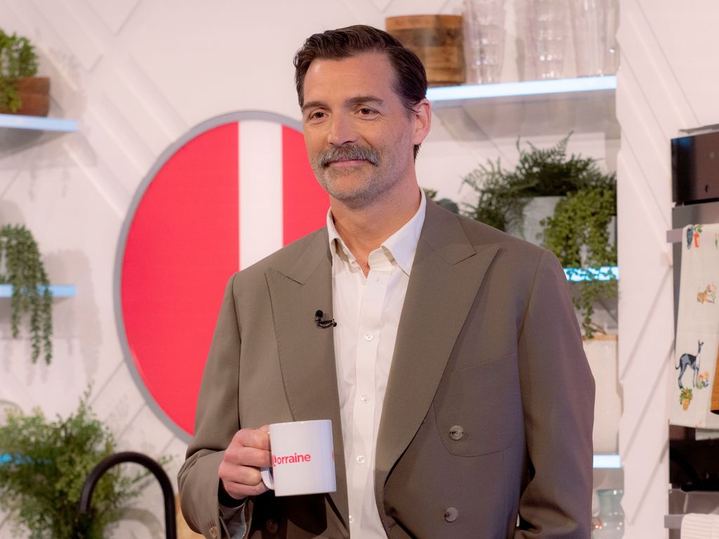 Patrick Grant on Lorraine in a suit holding a mug