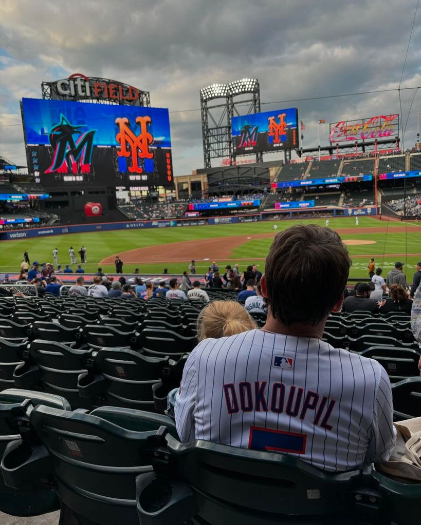 Tony Dokoupil sits with his daughter watching baseball