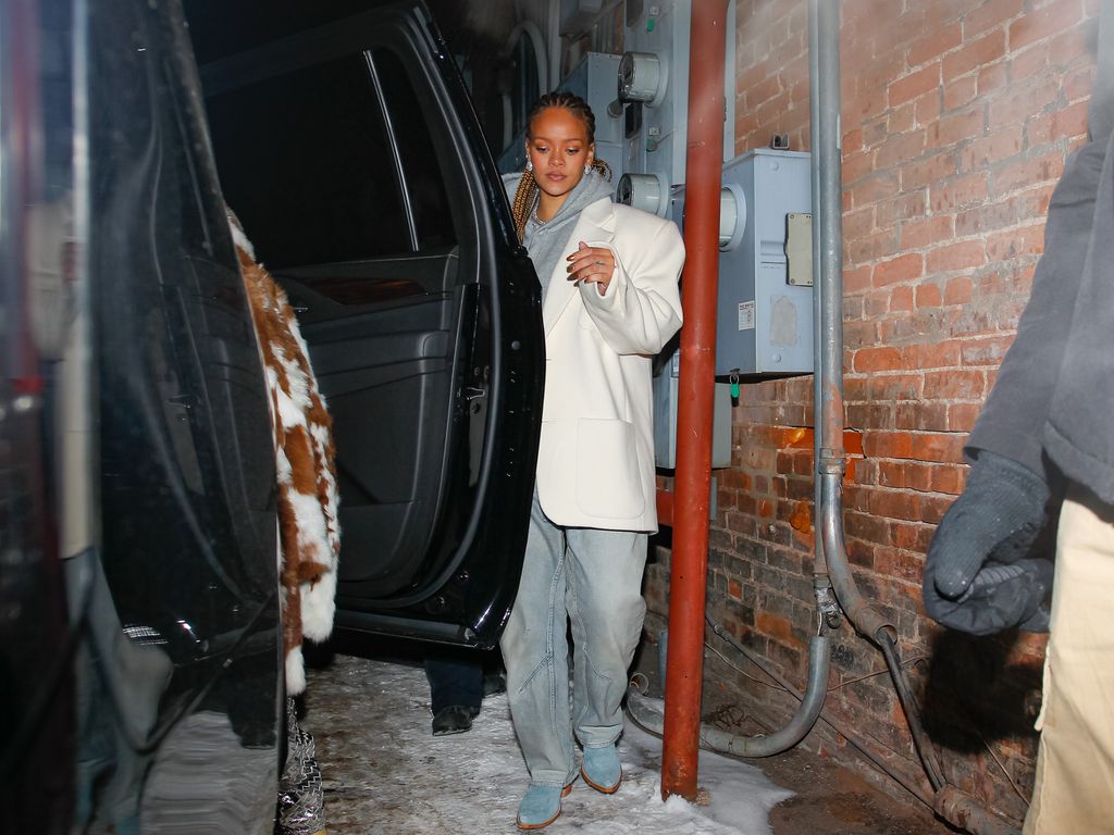 Rihanna wearing a coat and jeans