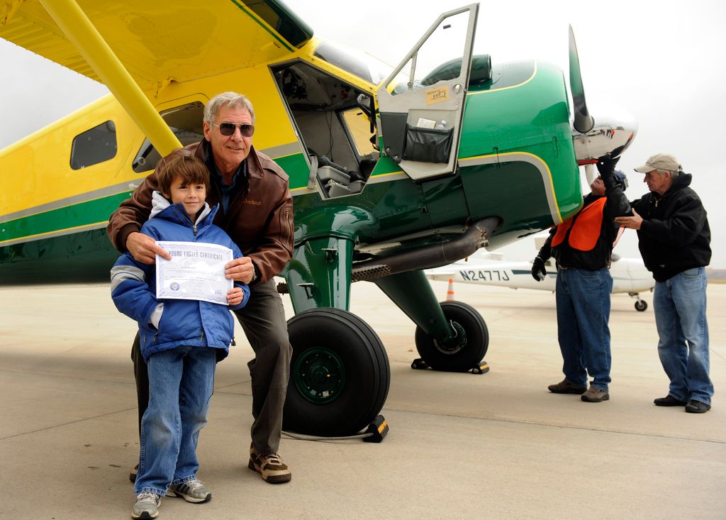 Actor Harrison Ford visits Denver and gives some kids an airplane ride from Centennial Airport. Sean Keeney, 8, of Littleton gets his photo taken with Ford after his plane ride. For Bill Husted column. Kathryn Scott Osler, The Denver Post