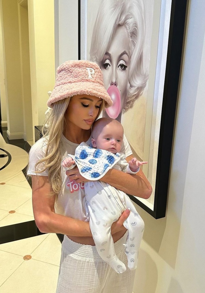 Photo shared by Paris Hilton on Instagram January 16 in a 1st birthday tribute to her son Phoenix, where she is carrying him, behind them a poster of Marilyn Monroe