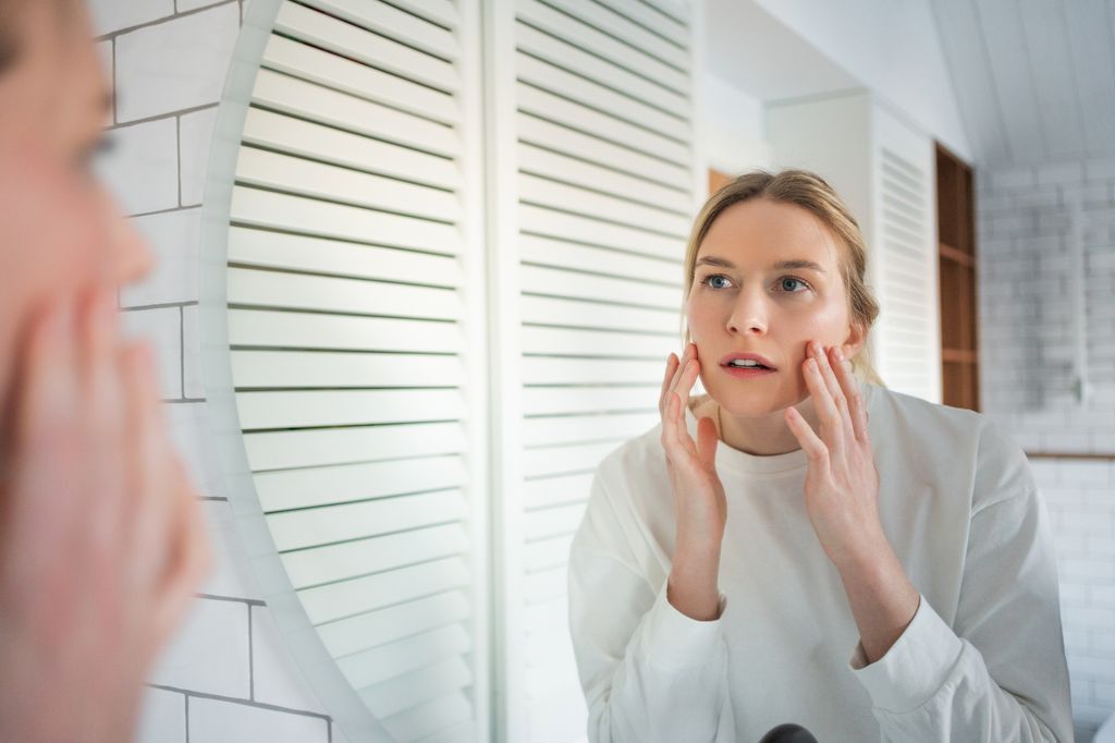 woman looking in mirror