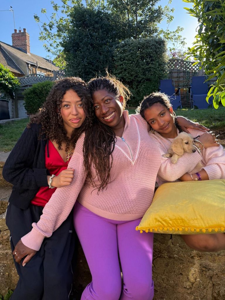 woman with two teenage dogs and a puppy