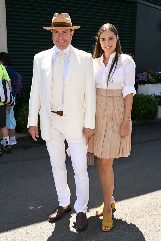 Amber Le Bon attended day five with her dad Simon in a nude pleated skirt with a white shirt tucked in and