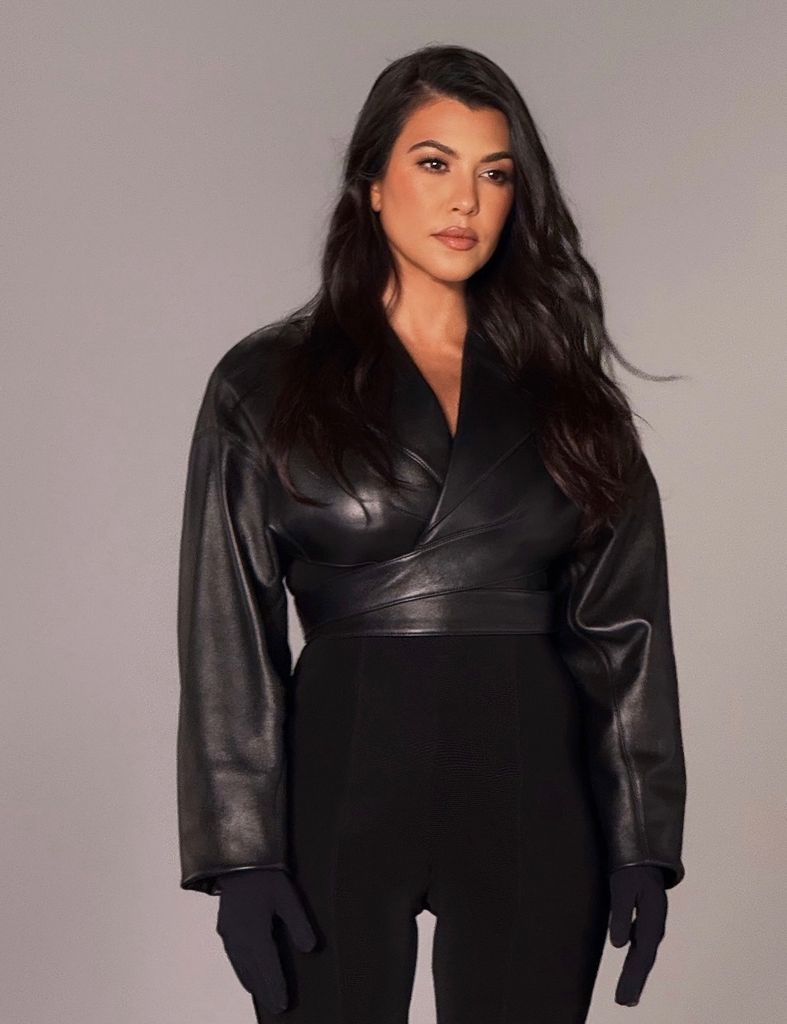 Kourtney Kardashian in all black, looking serious
