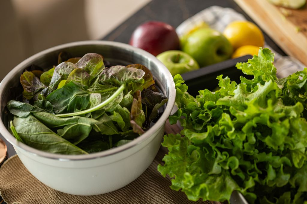 Close up of fresh spinach leaves in a bowl by the organic lettuce