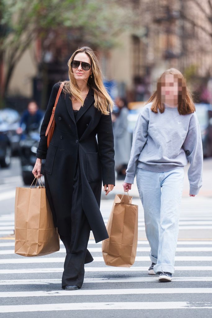 mother and daughter crossing road in new york 