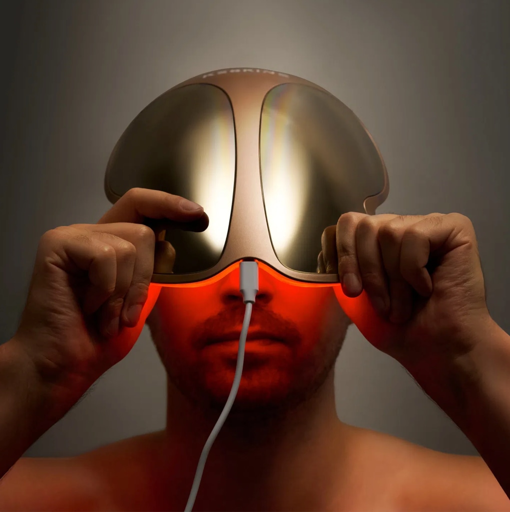 Man applying Keskine LED Light Therapy Face Mask Pro to his face