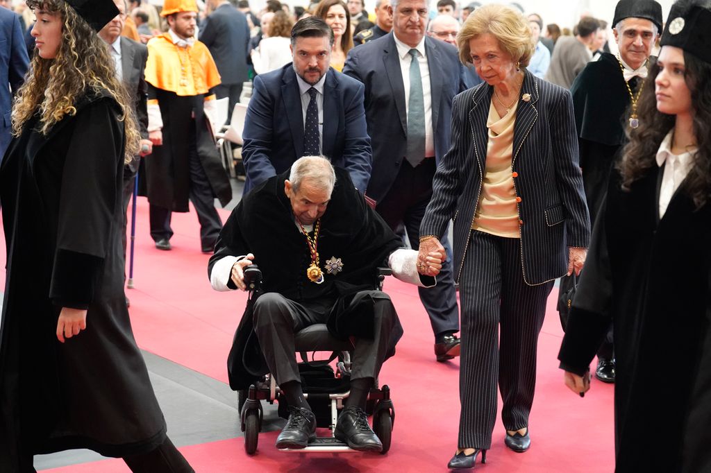 Queen Sofia holds hands with Emilio Lora-Tamayo 